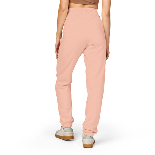 Person wearing light pink sweatpants on a white background