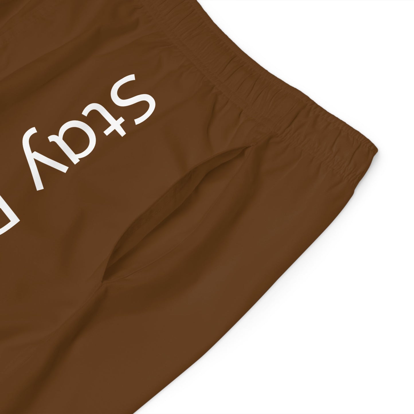 Close-up of brown Stay Golden Men's Board Shorts with elastic waistband and side pocket detail