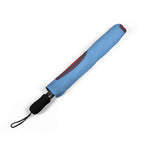 Blue foldable umbrella with heart print and black handle in protective sleeve