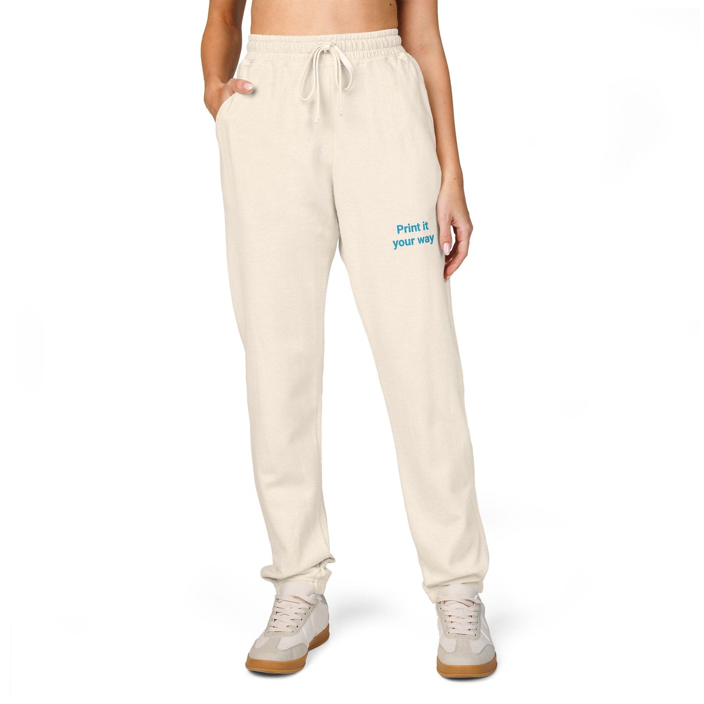 Beige sweatpants with text on a white background