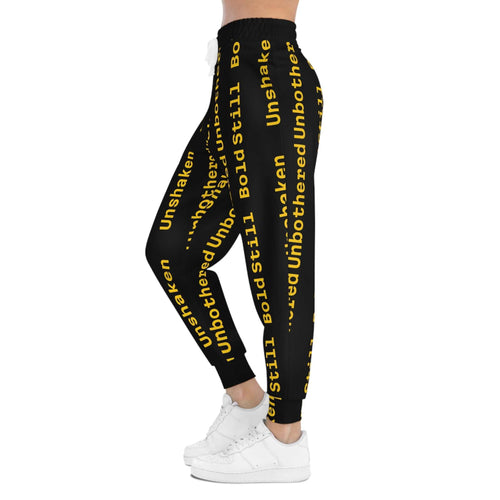 Eco-friendly black joggers with yellow "Unbothered, Unshaken & Bold Still Vibes" text print and elastic waistband