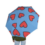Blue foldable umbrella with red heart prints, lightweight and semi-automatic for travel use