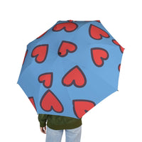 Blue foldable umbrella with red heart prints, lightweight and semi-automatic for travel use