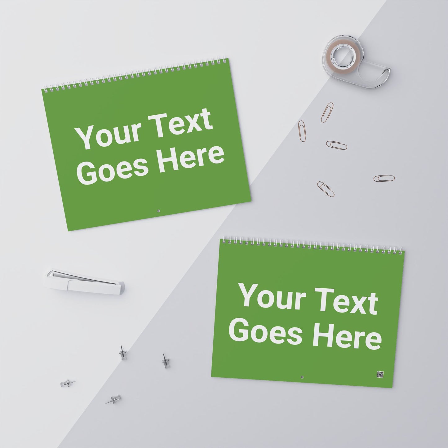 Two green signs with 'Your Text Goes Here' text on a white surface with office supplies.