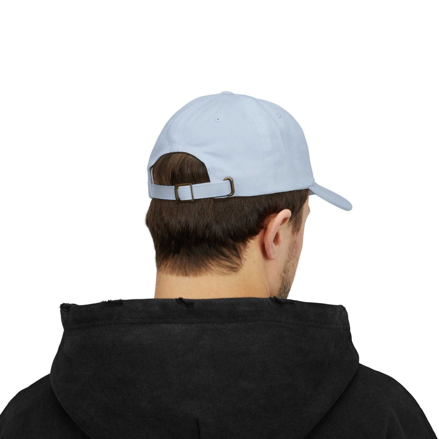 Back view of man wearing light blue classic cap with antique brass buckle strap and black hoodie