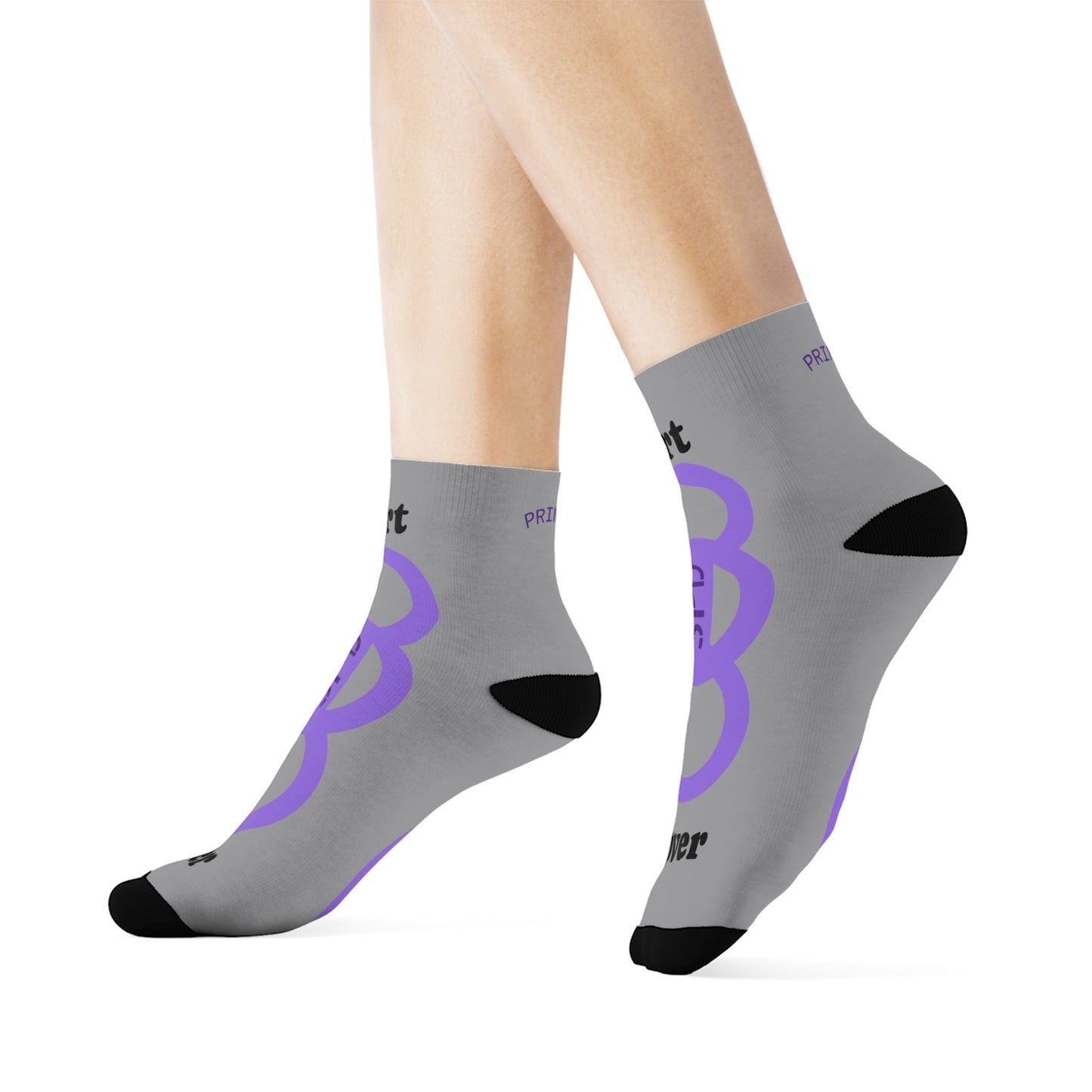 Gray socks with purple logo worn by a person on a white background