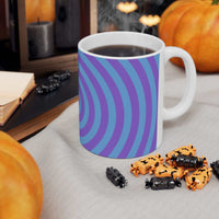 Vibrant Spiral Ceramic Mug with blue and purple spiral design filled with hot coffee on a table surrounded by Halloween decorations