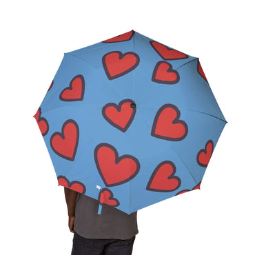 Heart print foldable umbrella with vibrant blue background and red hearts, lightweight and portable for travel and daily use