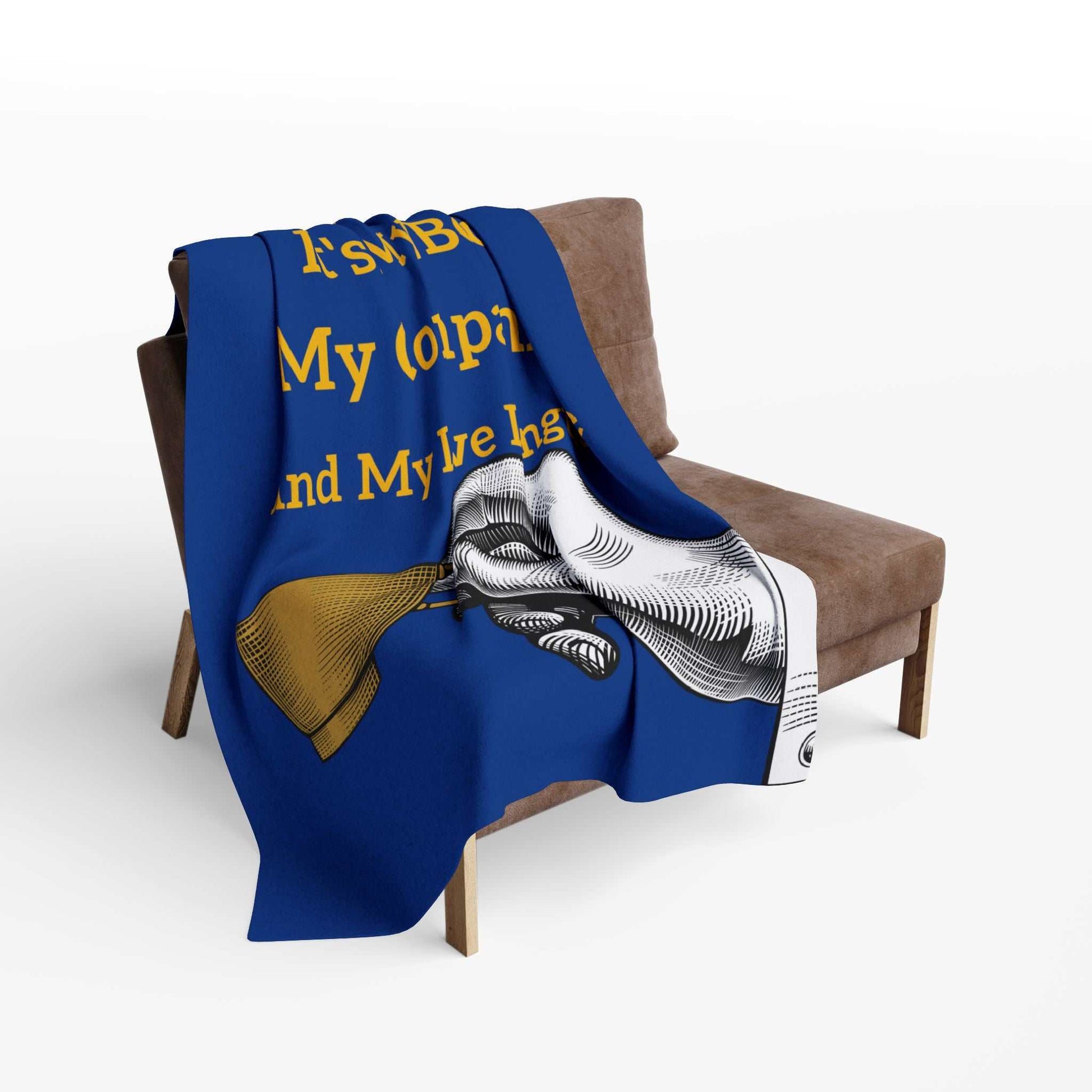 Coffee Lover's Cozy Fleece Blanket draped on chair with coffee-themed design and bold blue color