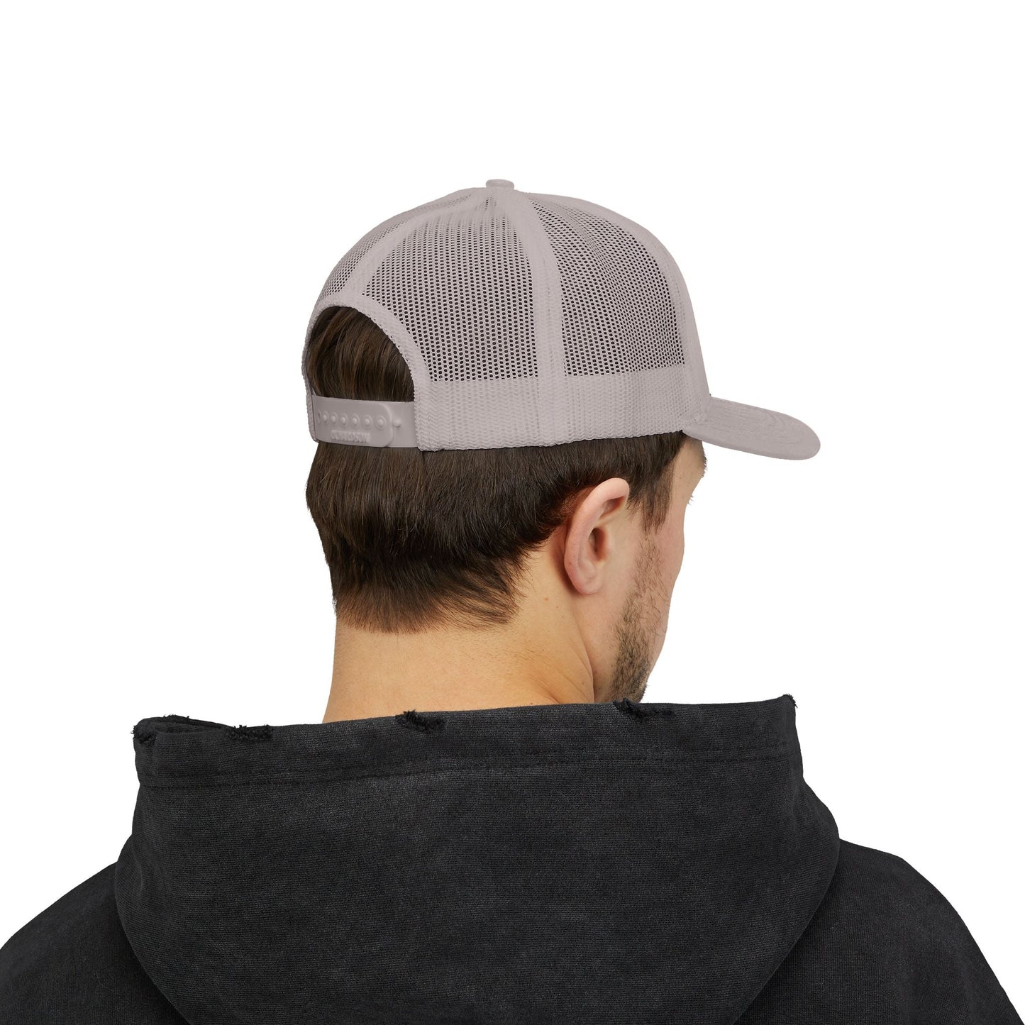 Man wearing gray snapback trucker cap with mesh back and adjustable snap closure viewed from behind