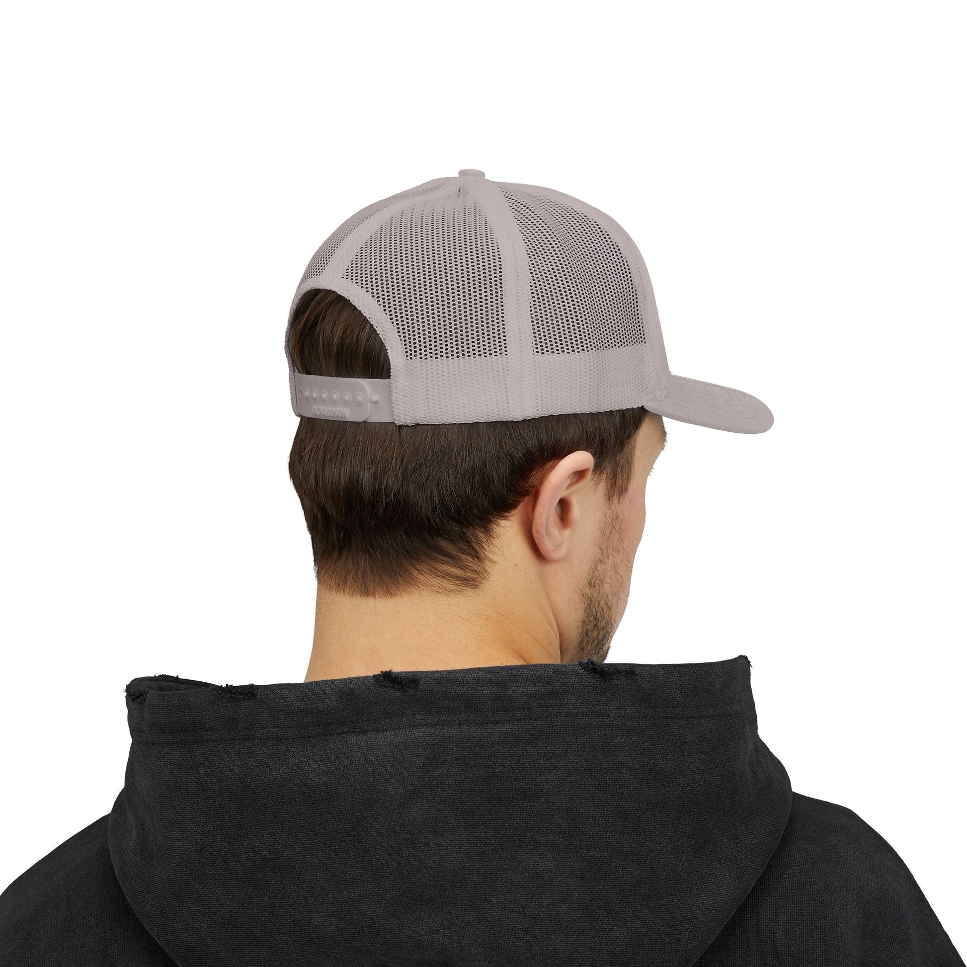 Man wearing gray snapback trucker cap with mesh back and adjustable snap closure viewed from behind