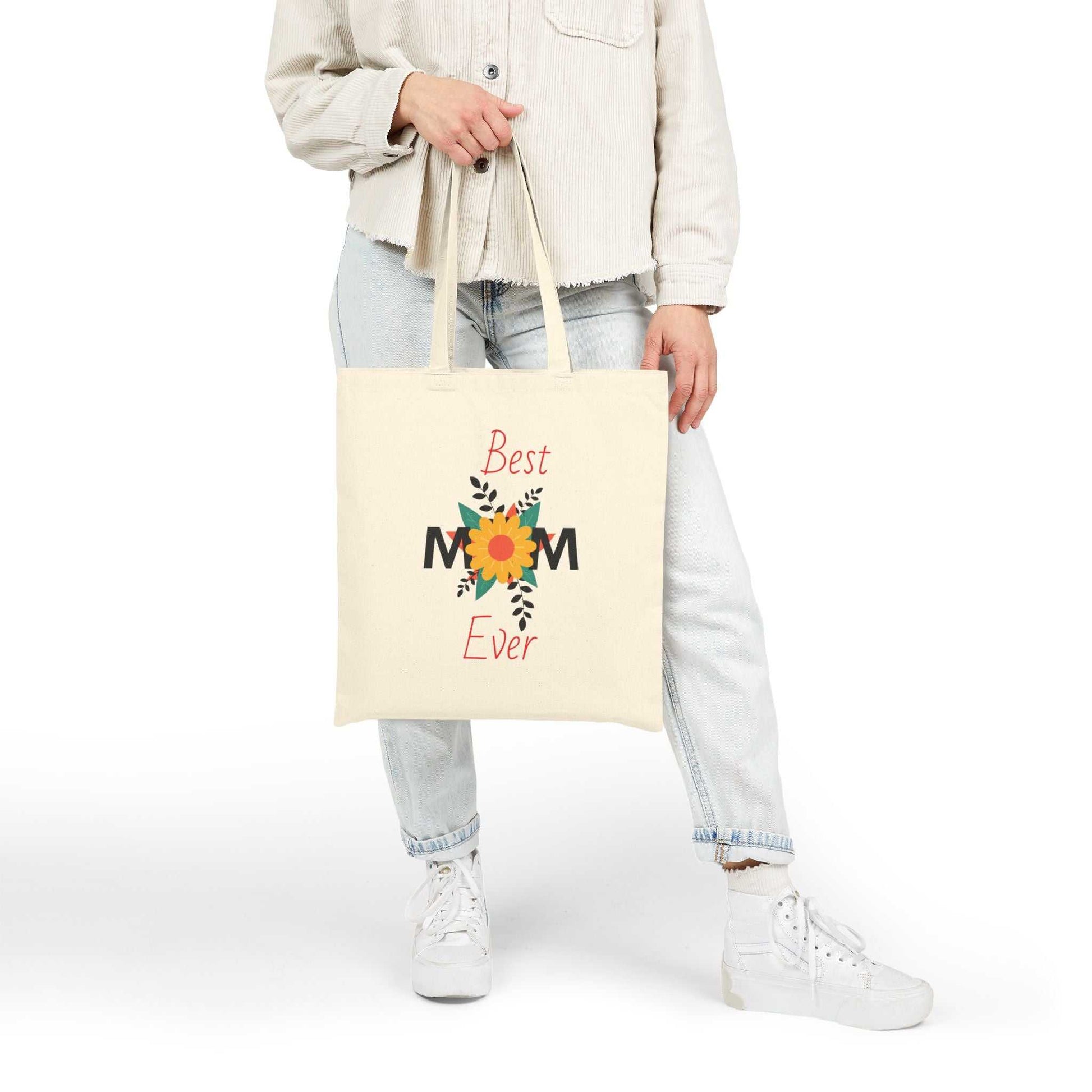 Woman holding Best Mom Ever cotton canvas tote bag with floral design