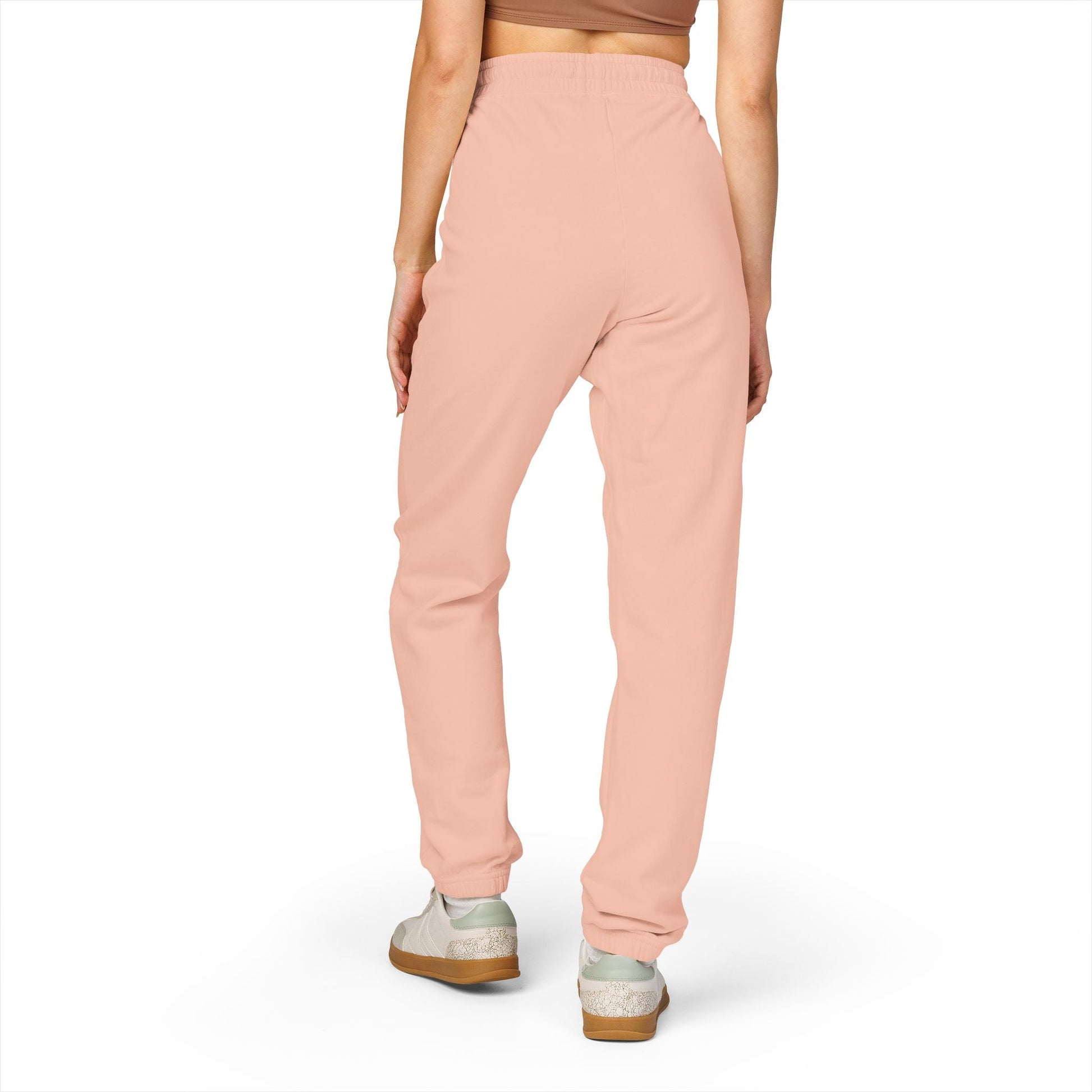 Back view of comfortable unisex fleece sweatpants in soft pink with relaxed fit and elastic waistband