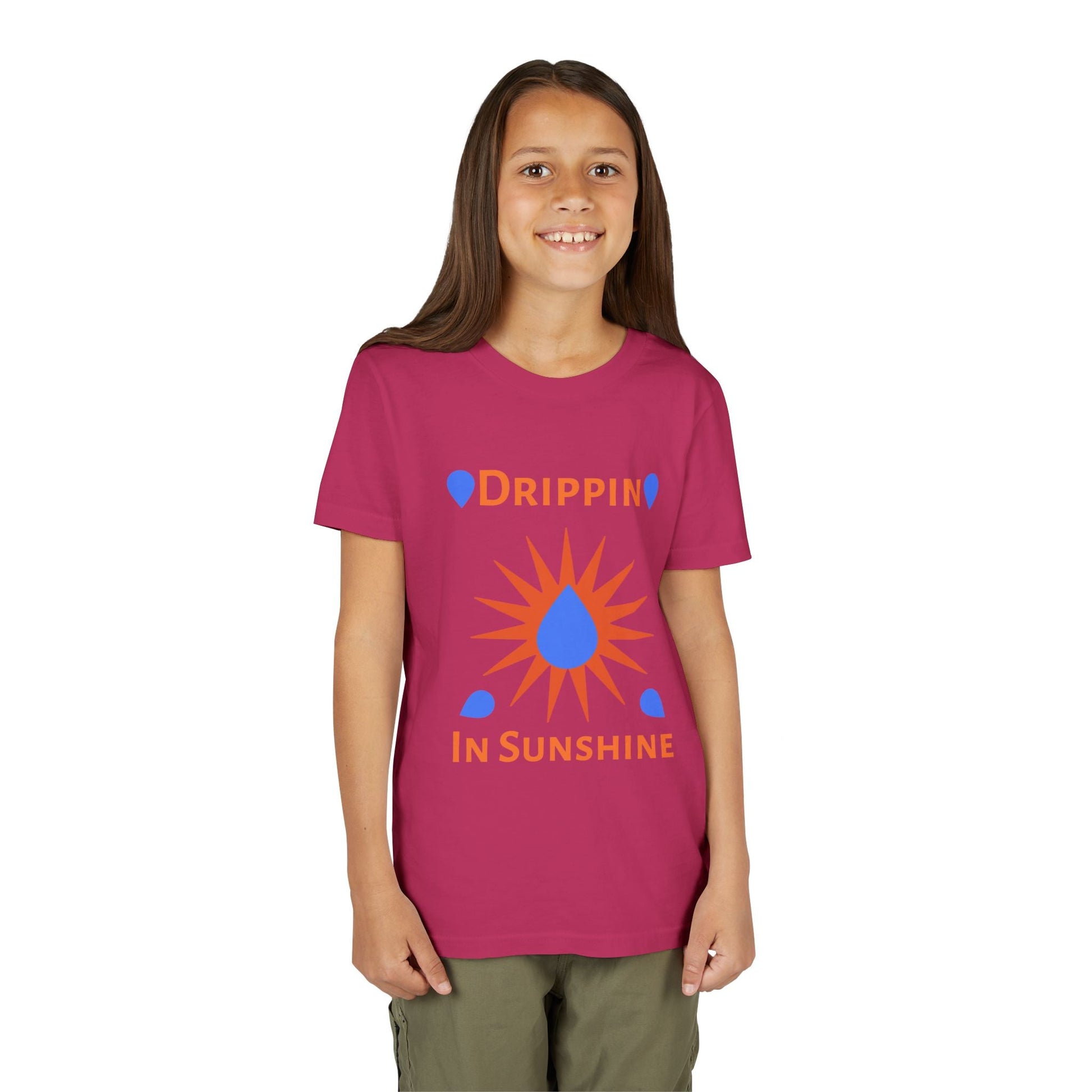 Child wearing pink youth short sleeve tee with "Drippin' in Sunshine" graphic and sun design