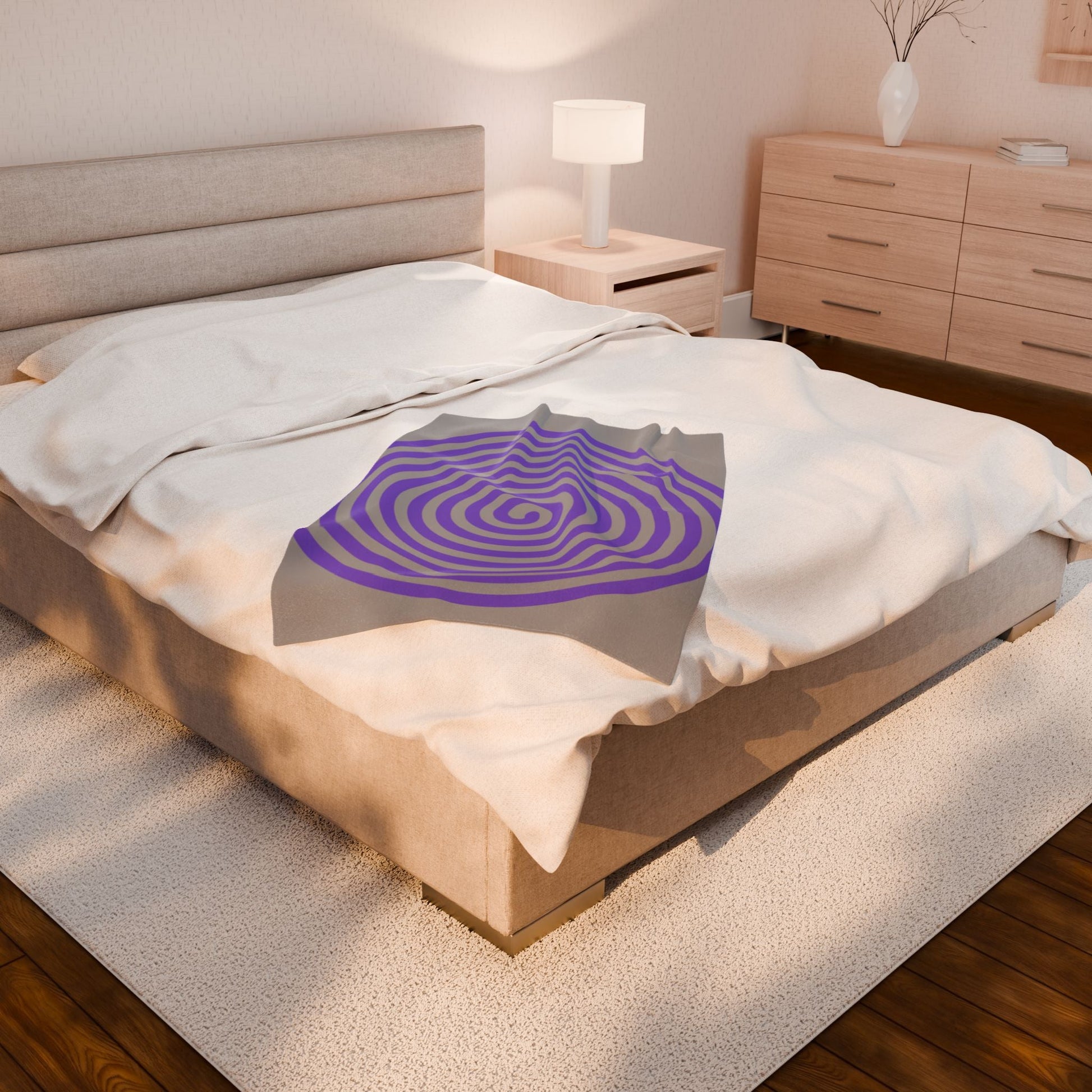 Plush blanket with purple spiral design on bed in cozy modern bedroom setup