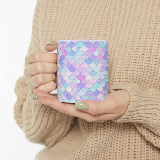 Vibrant Shell Ceramic Mug with colorful pastel shell pattern held by person in beige sweater