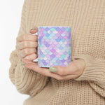 Vibrant Shell Ceramic Mug with colorful pastel shell pattern held by person in beige sweater