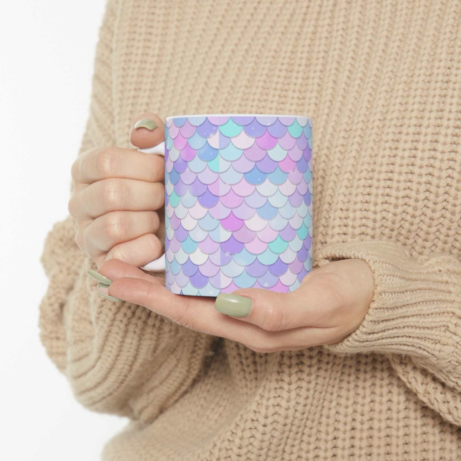 Vibrant Shell Ceramic Mug with colorful pastel shell pattern held by person in beige sweater