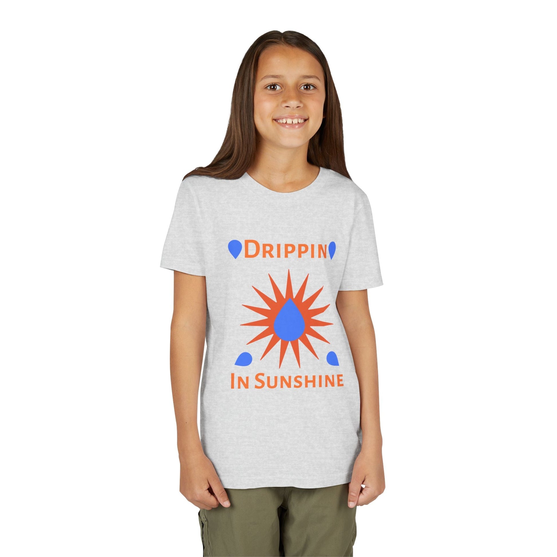Child wearing a grey youth short sleeve tee with "Drippin in Sunshine" graphic and green pants
