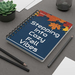 Autumn-Inspired Spiral Bound Journal with fall leaves cover and cozy fall vibes text on gray desk with pencils and succulent plant