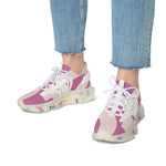 Women's mesh sneakers in pink and beige with white laces and multicolor sole worn with blue jeans