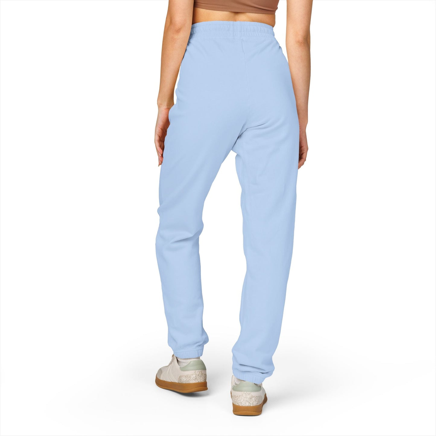Back view of person wearing light blue comfortable unisex fleece sweatpants with relaxed fit and elastic waistband