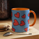 Vibrant Love Accent Coffee Mug with red hearts on blue exterior and orange handle and interior, microwave and dishwasher safe ceramic mug