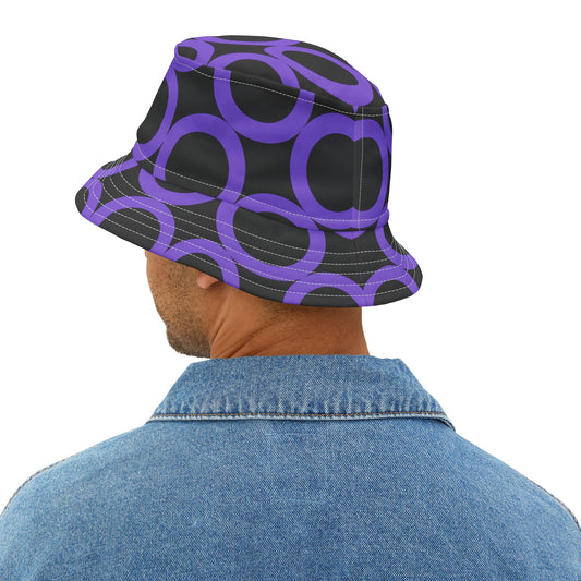 Man wearing purple dot pattern bucket hat with adjustable fit and denim jacket, black background