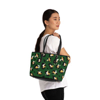 Stylish leopard print shoulder bag in green with black handles worn by woman