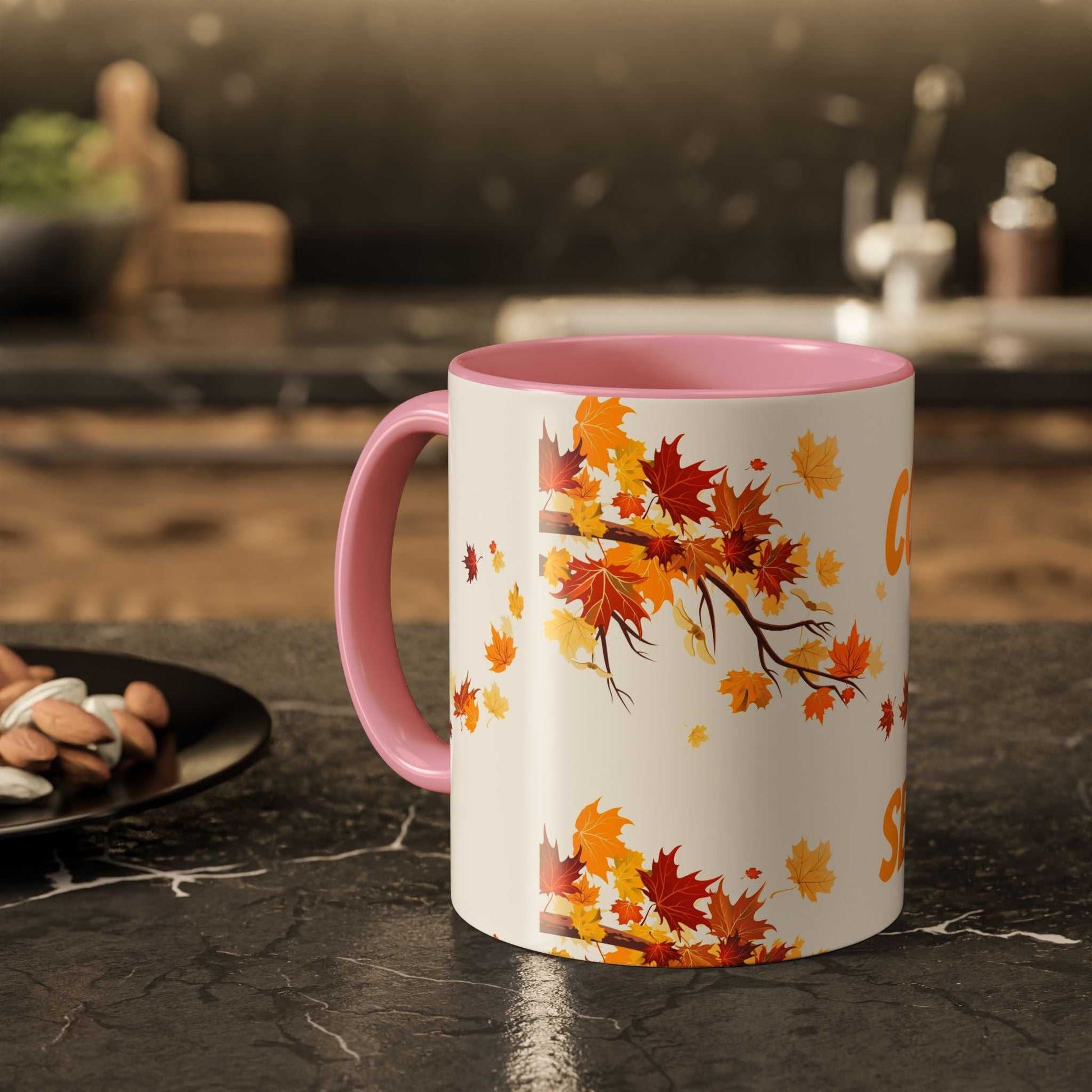 Fall Cozy Season Mug with autumn leaves design and pink handle on kitchen counter