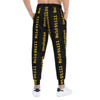 Eco-friendly black joggers with bold yellow motivational text, adjustable waistband, side pockets, and tapered ankle cuffs for casual and athletic wear