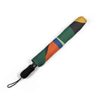 Compact foldable umbrella with colorful geometric pattern and black handle for easy carrying
