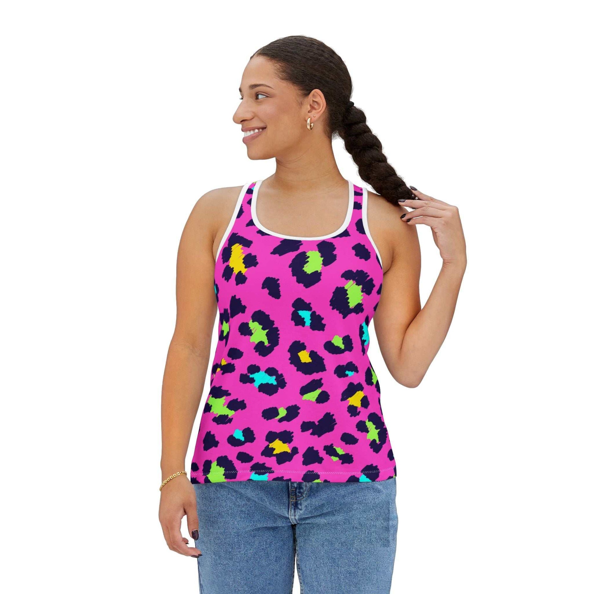 Woman wearing vibrant leopard print tank top with bright pink background and colorful spots