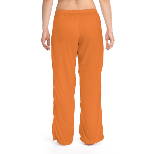 Orange pants worn by a person on a white background