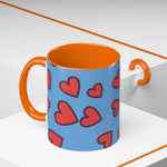 Vibrant Love Accent Coffee Mug with red hearts on blue exterior and orange interior and handle
