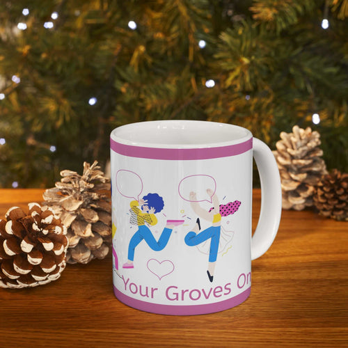 Get Your Groves On ceramic mug with colorful dancing figures and purple border on wooden table with pine cones and holiday lights background