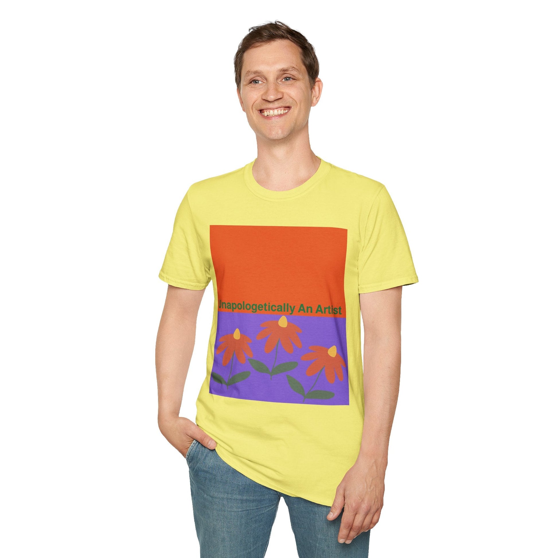 Smiling man wearing yellow Unapologetically An Artist T-Shirt with floral design and bold text on front