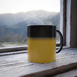 Color changing mug with black and yellow heat-sensitive ceramic design steaming on windowsill