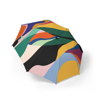 Colorful foldable umbrella with abstract pattern, compact travel rain and sun protection accessory