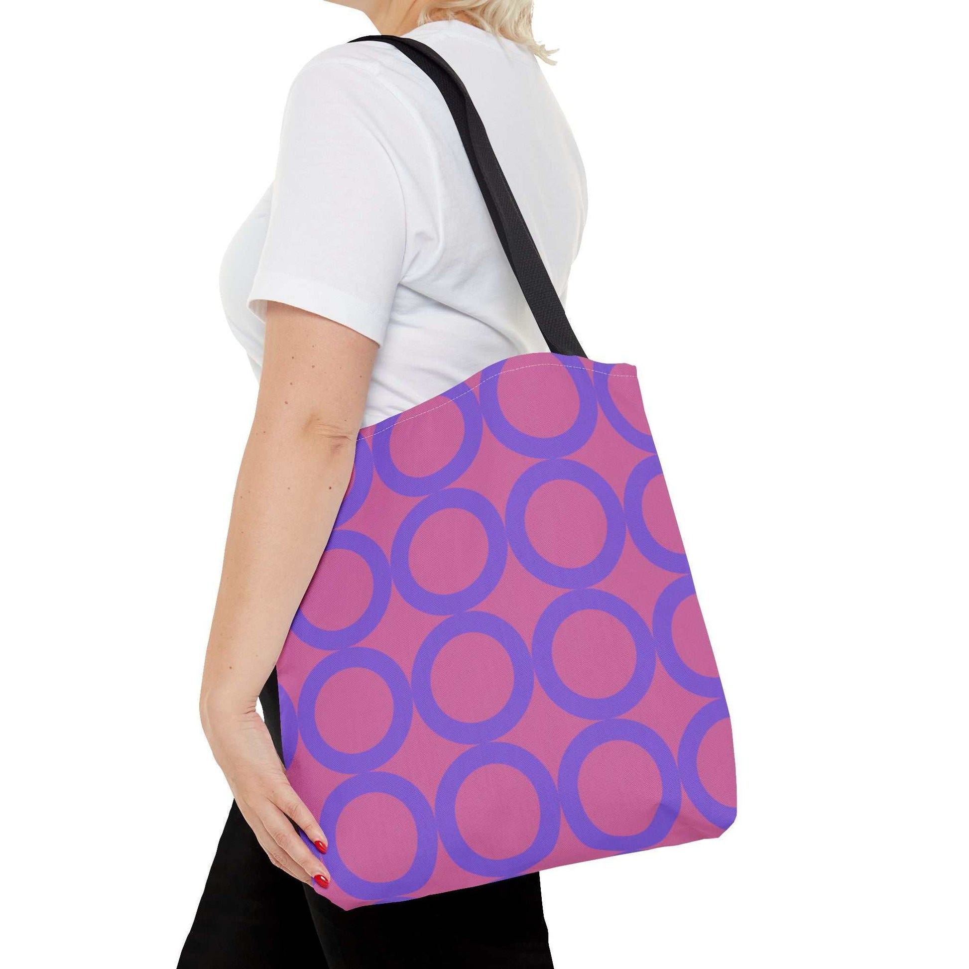 Chic light pink and purple circle tote bag with black handles, eco-friendly shopping bag on shoulder
