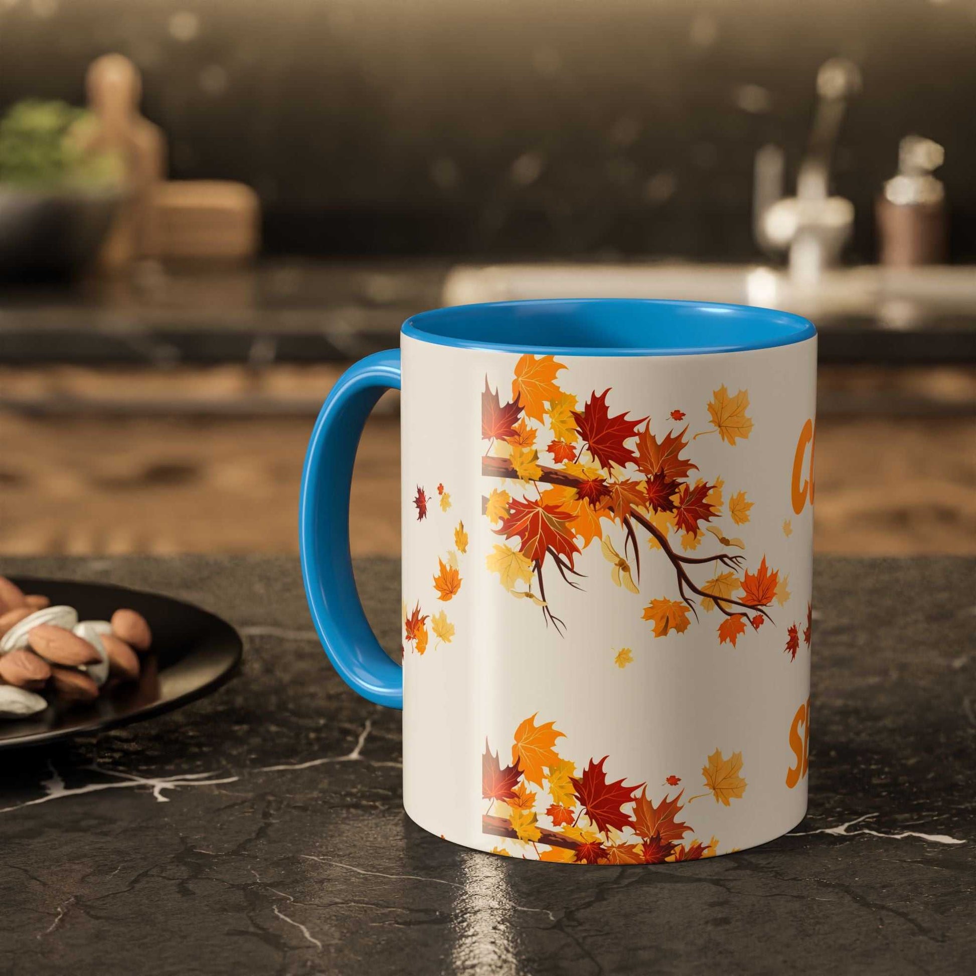 Fall cozy season mug with autumn leaves design and blue handle, ideal for Thanksgiving and seasonal drinks