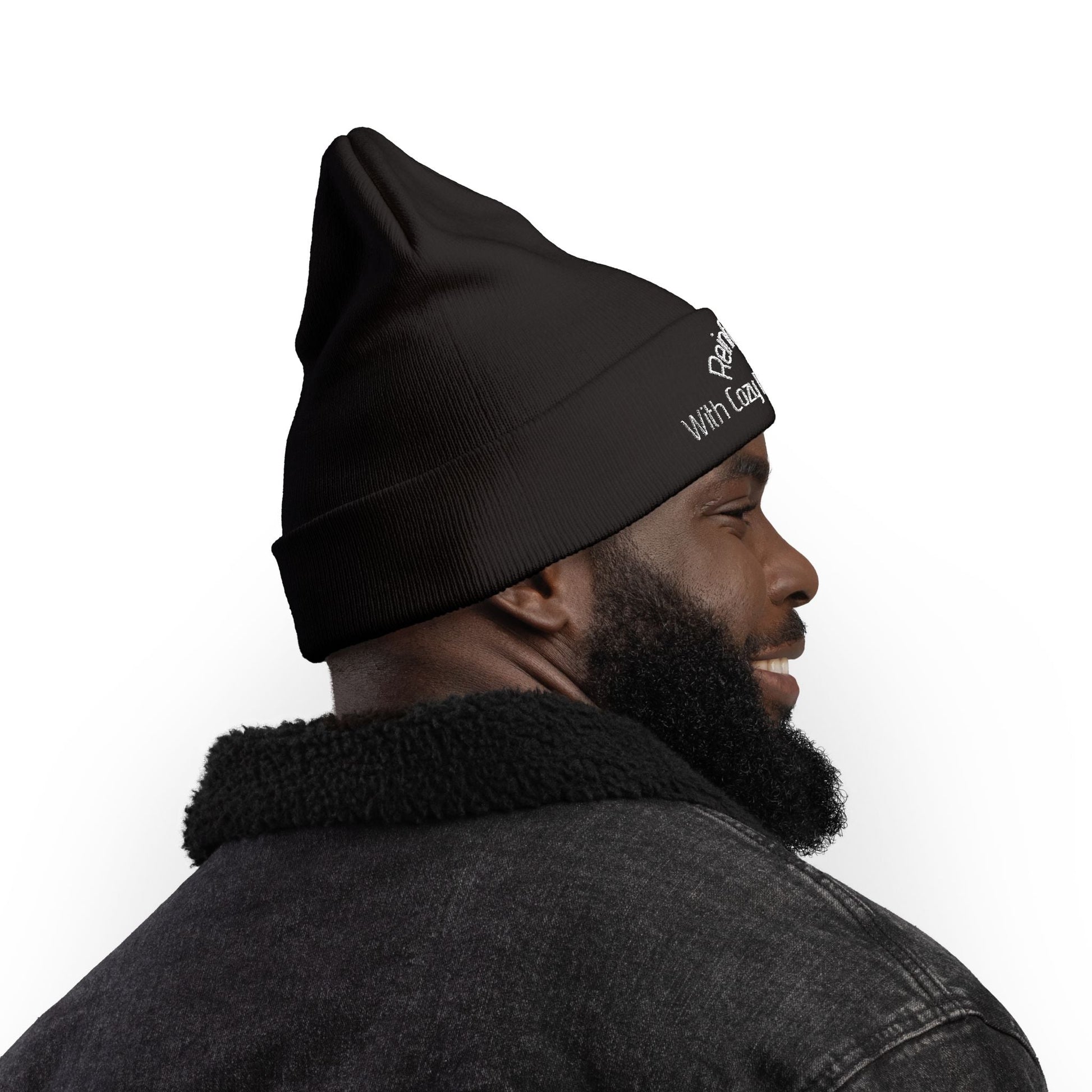 Man wearing black knit beanie with embroidered text, cozy winter hat, stylish outdoor accessory