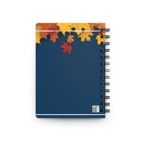 Autumn-inspired spiral bound journal with colorful fall leaves on dark blue cover for creative writing and reflection
