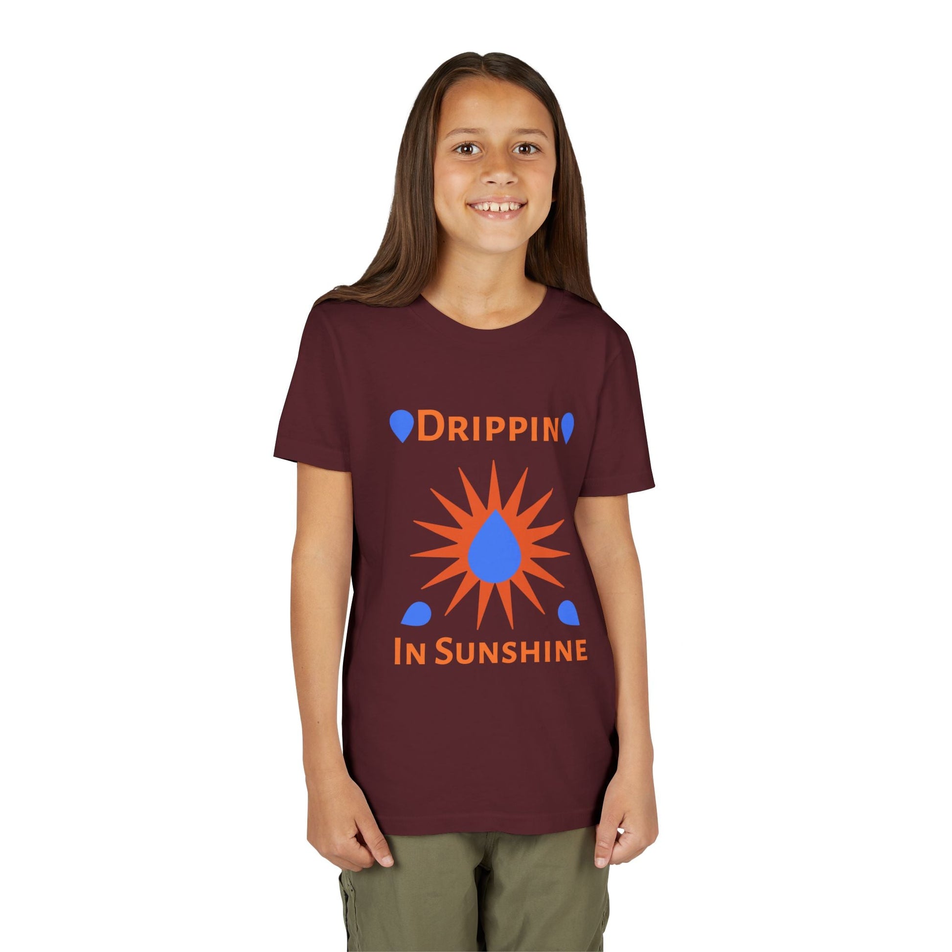 Child wearing maroon youth short sleeve tee with "Drippin in Sunshine" graphic design
