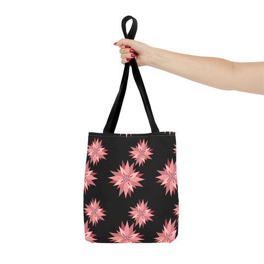 Colorful AOP Tote Bag with pink floral design held by hand, reusable and stylish shopping bag