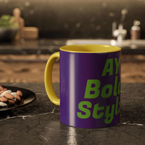 Colorful custom mug with purple exterior and yellow handle and interior, featuring bold green text, ideal for coffee lovers and vibrant home decor
