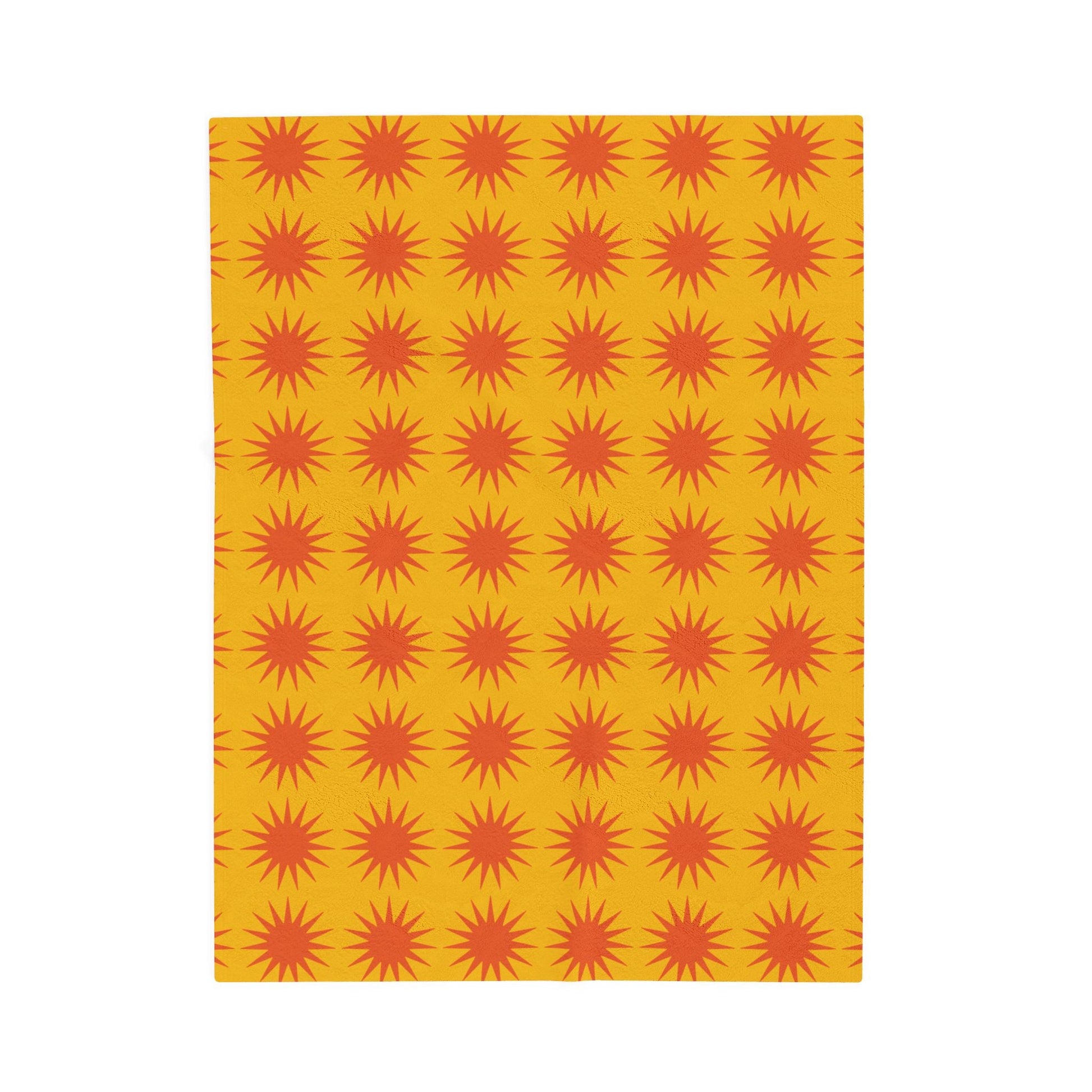 Cozy velveteen plush blanket with vibrant orange sunburst pattern on yellow background for home decor and comfort
