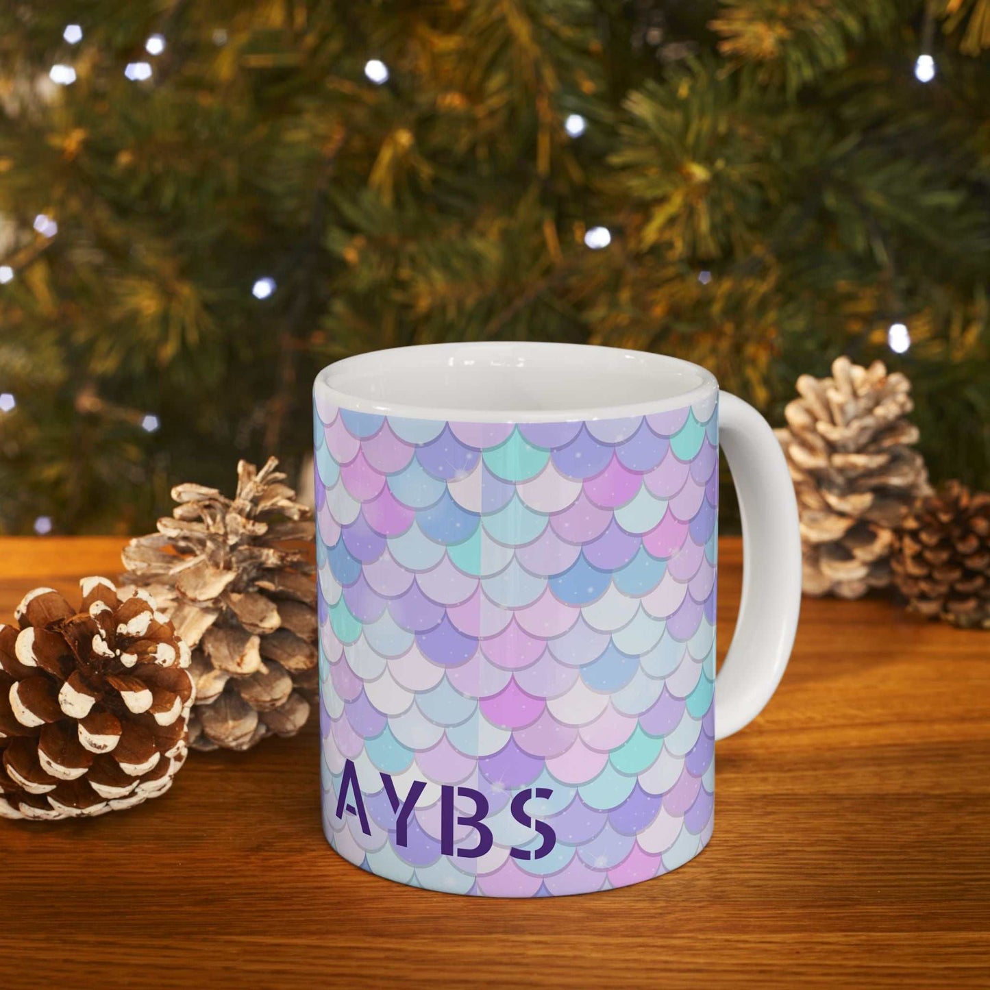 Vibrant Shell Ceramic Mug with colorful pastel shell pattern and glossy finish on wooden table with pinecones and Christmas lights background