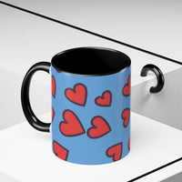 Vibrant Love Accent Coffee Mug with red hearts on blue background, black handle and interior, microwave and dishwasher safe ceramic mug