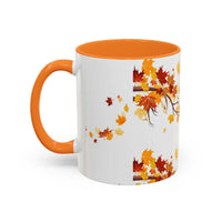 White ceramic fall cozy season mug with orange handle and colorful autumn leaves design
